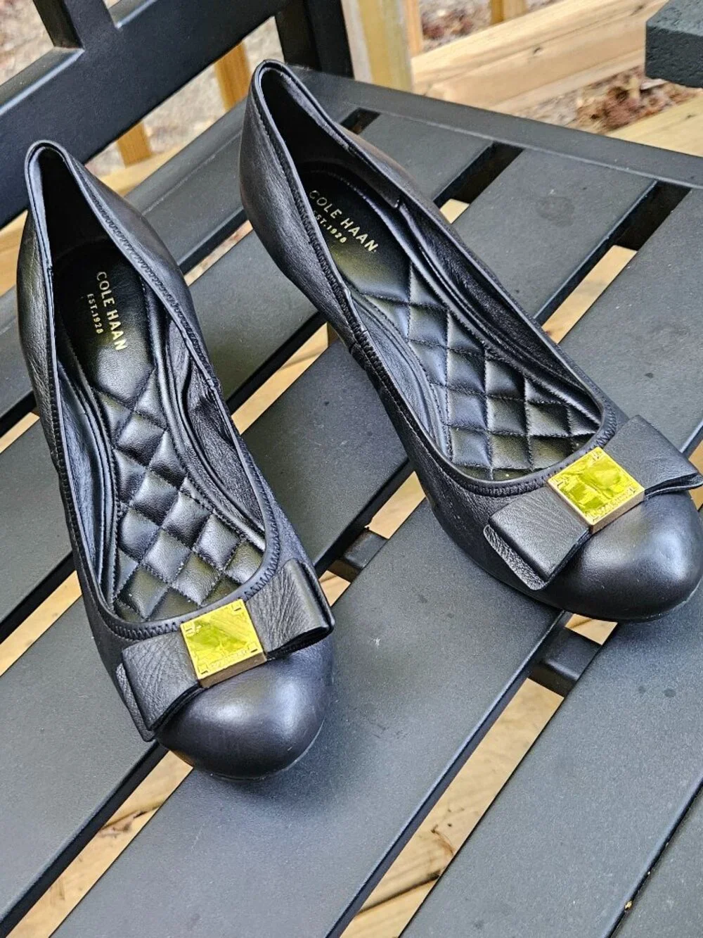 Cole Haan Black Leather Wedge Pumps with Gold Bow Accent